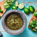 salsa verde in stone molcajete flat lay composition